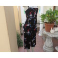 Ultra sexy black cropped jumpsuit with colourful flowers.In stretch polyester.Strappy top.Size 30/6