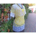 Adorable acrylic lace long empire cross over top in yellow and cream with strappy top.Size 38/14.