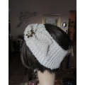 Charming wide hand knitted acrylic cream headband with bow at side. Glamour pin on bow. As new.
