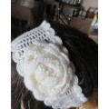Delicate crochet acrylic stretch cream headband fasten with button at back and flower at side.