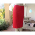 Smart red pencil skirt in red jersey fabric with some stretch.Size 42/18. Pleat at back. As new.