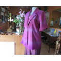 Feel sensational in this shiny short sleeve jacket in shades of pink/purple.Size 40 to 42. New cond.
