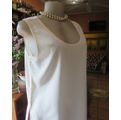 Cream cami style slip over silky polyester top by CONTRADICT size 36/12. Slits at sides.Scooped neck