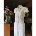 Charming white button down tailored top with tucked seams on front and on capped sleeves.Size 32/34