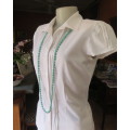 Charming white button down tailored top with tucked seams on front and on capped sleeves.Size 32/34