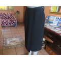 Top of the line black cross over fully lined honeycomb polyester size 38 skirt by WOOLWORTHS.As new
