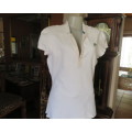 Ladies NIKE sports golf style top in white with capped sleeves. Button down short opening.Size 40/42