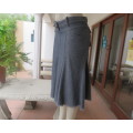 Unique grey/blue denim gored skirt with yoked waistband.Pocket at front and back. Size 34/10 As new.