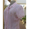 Pretty cool soft pink floral embroidered sheer polyester top.Button down with collar.Size 34. As new