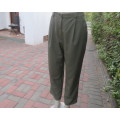 Dress pants in dark olive with tailored side pockets.Pleated front.Tapered legs. ize 36/12.As new