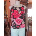 Cute black poly top with bold magenta pink flowers.Drawstring in neckline.Long back slit.Size 36.