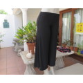 Smart black wide legged stretch polyester ankle pants with elasticated waist. Boutique made.Size 32.