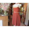 Sweet brick colour size 32 dress with permanent pleated bottom.Strappy top/lace decoration.As new