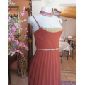 Sweet brick colour size 32 dress with permanent pleated bottom.Strappy top/lace decoration.As new
