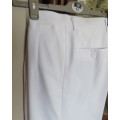 Handsome men`s white trousers by LION KNIGHT size 34 in cotton/terylene and silk.Pleated front.