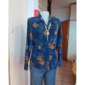 Beautiful royal blue tailored top with caramel roses.Button down/shirt collar.Size 34 by MILADY`S.