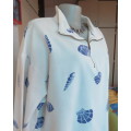 Warm long sleeve white slip over top with blue shells.Zip up front opening and high collar.Size XL