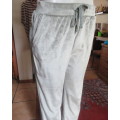 Soft stretch polyester velvet pants.Wide elasticated waist with drawstring.Pockets.Size 34/10