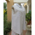 Cool pale blue sleeveless bubble cotton top with button down front.Size 40 to 42.Two cute pockets.