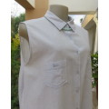 Cool pale blue sleeveless bubble cotton top with button down front.Size 40 to 42.Two cute pockets.