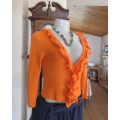 Chic long sleeve stretch polycotton knit cardigan in fire orange. Size 34/10.By BNE.Lovely frill.