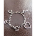 Cute chain bracelet with 3 hearts and 1 small key.With pinkish stones. Length 18cm.As new.