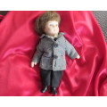 Antique little boy doll in suite with shoes..Movable arms and legs. Length 14cm.