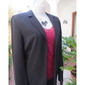 Sophisticated long black one button long sleeve jacket with open cloverleaf collar.Size 32/8.As new.