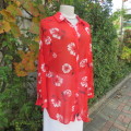 Eye catching red with white floral long top in sheer polyester. Cuffed sleeves. Size 36 by MILADY`S.
