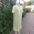 Summer vintage dress in lemon yellow poly/rayon fabric. Short sleeves. Shoulder pleats. Size 38/14.
