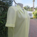 Summer vintage dress in lemon yellow poly/rayon fabric. Short sleeves. Shoulder pleats. Size 38/14.