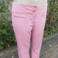 Dusty pink straight legged dress pants in rich polyester blends. Some stretch. Size 34/10. As new.