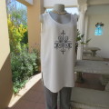 High quality long textured cream polyester top. Sleeveless. Exotic silver front embroidery. Size 36