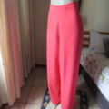 Smart crimson colour owner made pants with flat front/elasticated back. Size 48/24. Polyester crepe.