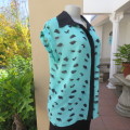 Cool sleeveless sheer turquoise poly top with black brush marks/collar/hidden button down.Size 36/12