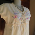 Lovely cream cotton capped sleeve slip over top. Braiding and colourful embroidery on front.Size 34.