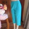 Capri style green jade boutique made polyester pants.High waist with side zip. Size 36/12. New cond.
