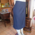 Elegant dark navy polyester pencil skirt. Upper calf length. Zip/pleat at back. Size 42 to 44.As new