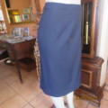 Elegant dark navy polyester pencil skirt. Upper calf length. Zip/pleat at back. Size 42 to 44.As new