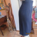 Elegant dark navy polyester pencil skirt. Upper calf length. Zip/pleat at back. Size 42 to 44.As new