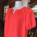 Fiery red slip over fully lined blouson top in textured polyester. Small front pleats.Size 36.As new