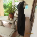 Elegant modern black jumpsuit with foldover skirt front. In 100% rayon.High collar.Size 38/14.As new