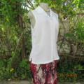 Cool sleeveless summer top in cream polyester. Pretty embroidery on collar and front.Size 36. As new