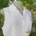 Cool sleeveless summer top in cream polyester. Pretty embroidery on collar and front.Size 36. As new