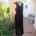 Black sexy stretch polyester jumpsuit with low frilled back/foldover front.By UTOPIA size 42.As new