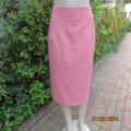 High waisted watermelon pink pencil skirt in heavy polyester. Zip at back.Owner made. Size 42.As new