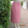High waisted watermelon pink pencil skirt in heavy polyester. Zip at back.Owner made. Size 42.As new
