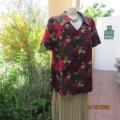 Silky polyester dark floral top in medley of colours. Short sleeves.V front/collar. Size 42. Slits