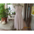 High quality sleeveless summer dress in ecru with white polkadots. Top lined. Pleated bottom.Size 34