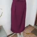 Elegant plum colour fully lined low calf length pencil skirt. Pleat and zip at back. Size 36.New con